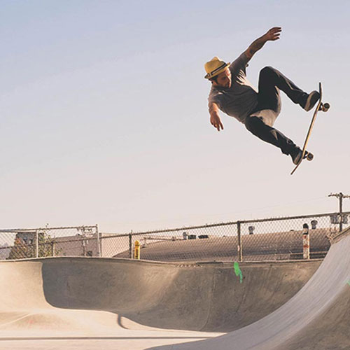 Skate boarder catching air on a half pipe
